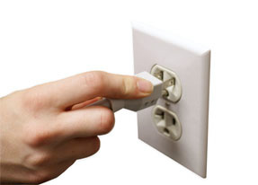 plugging the surge protector into the wall